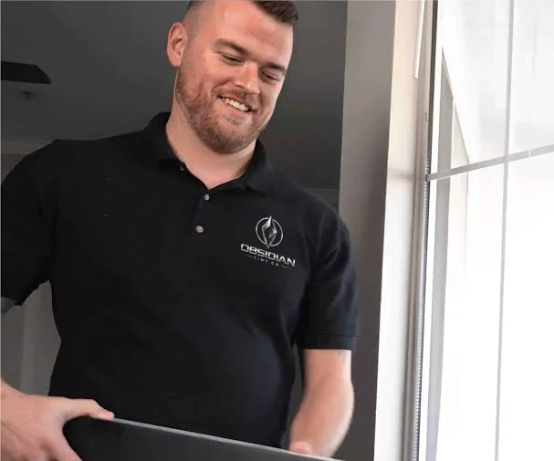 Shaun Horvath, owner of Obsidian Tint Co, smiling in his Obsidian Tint Co polo shirt